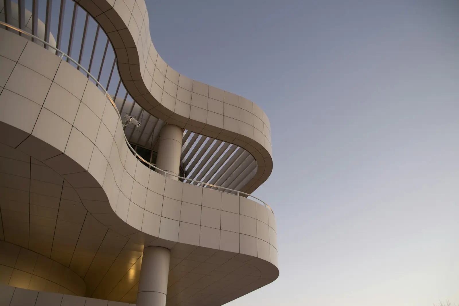 Geschwungene helle Fassade vor klarem Abendhimmel, aus der Masswerk-Markenwelt
